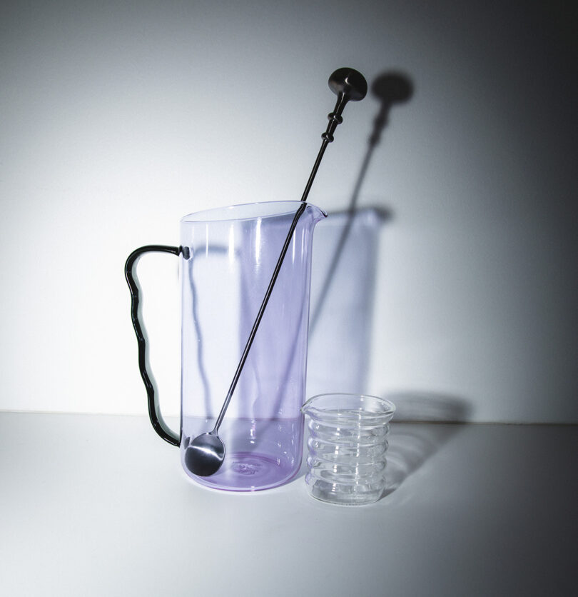 glass cocktail set with lilac pitcher, clear measuring glass, and stirrer