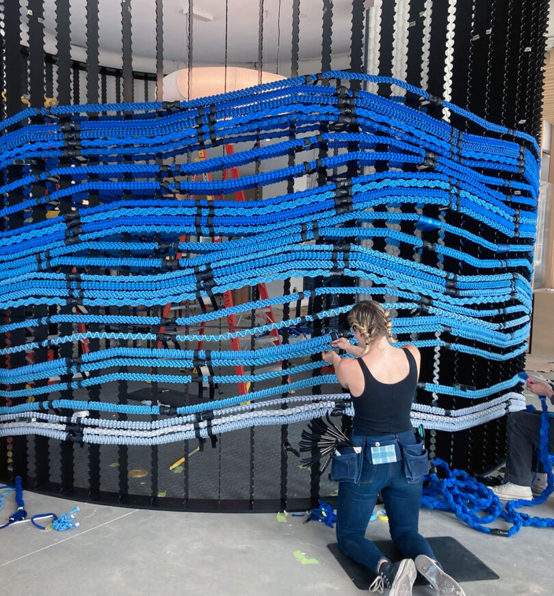 large blue handwoven art installation being made