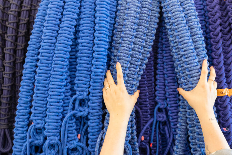 detail of large blue handwoven art installation being made