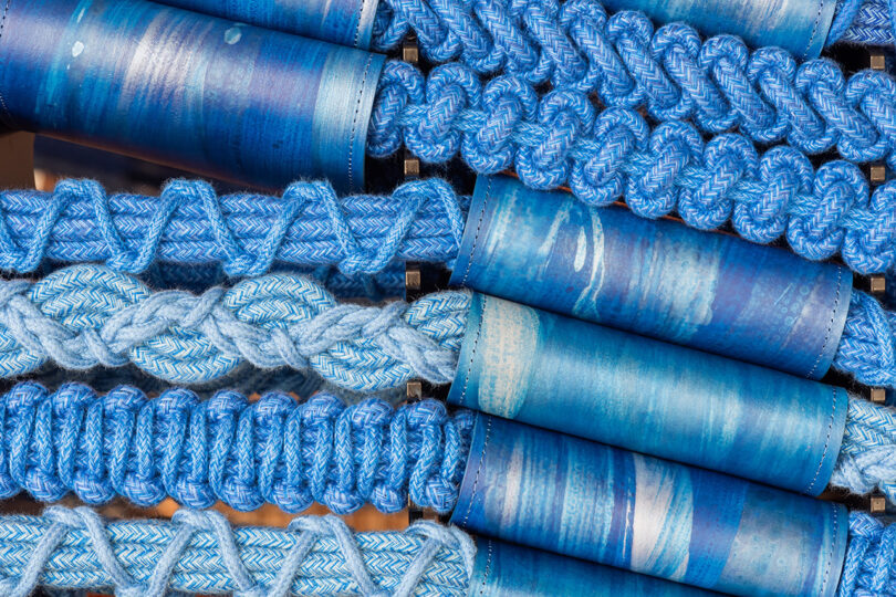 detail of large blue handwoven art installation being made