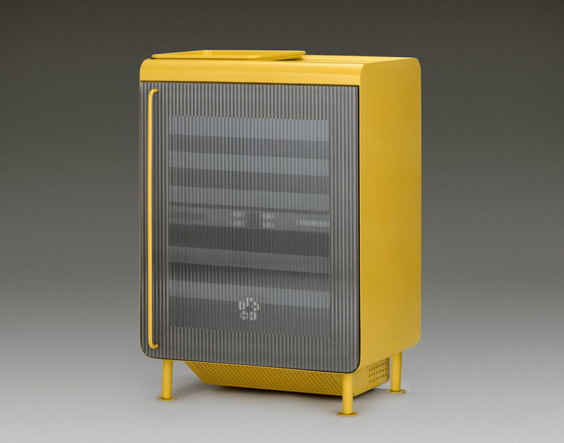 The Super Smart Fridge drinks fridge in bright yellow, with front of fridge featuring fluted glass and a matching yellow handle pull.