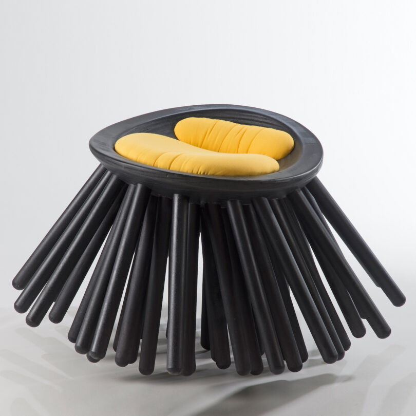 black sea urchin-inspired chair with orange cushions