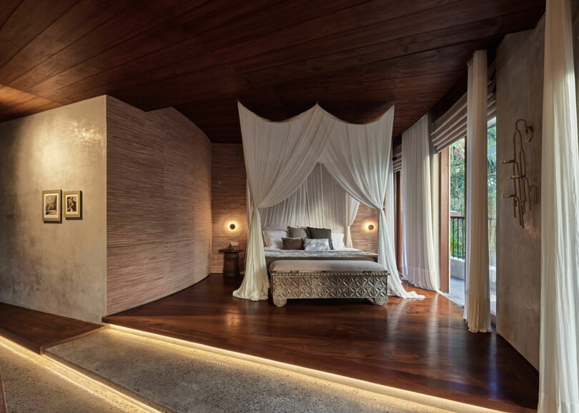 bedroom interior with curved exterior walls and canopy bed
