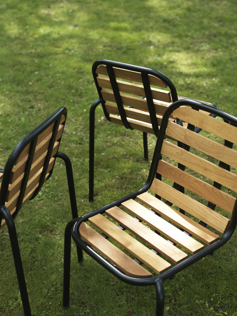 three dark green outdoor chairs outside
