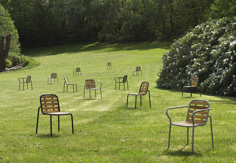dark green outdoor chairs and armchairs scattered across an open field
