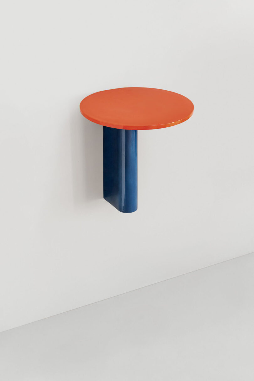 orange and blue wall-mounted table in white room
