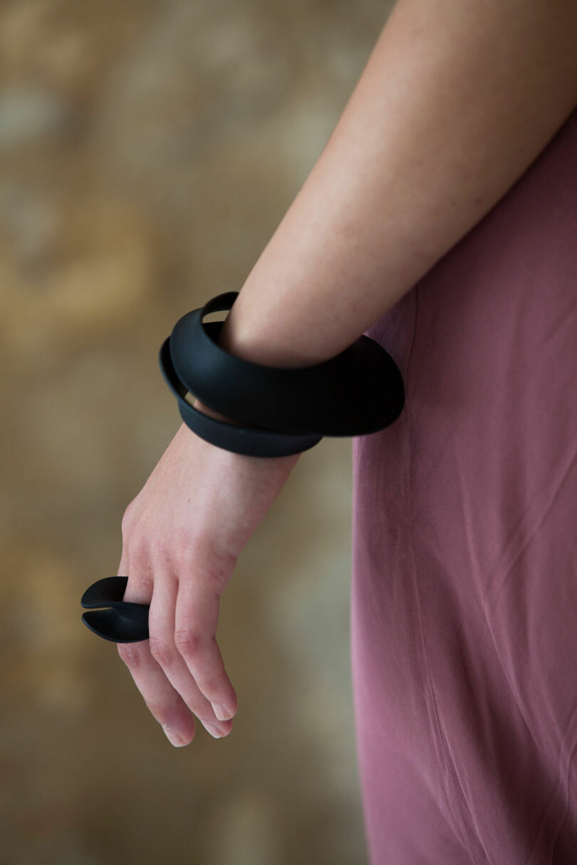 woman wearing black 3d printed jewelry