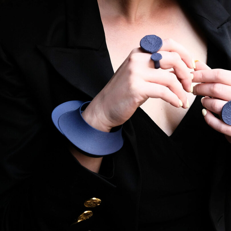 woman wearing navy 3d printed jewelry