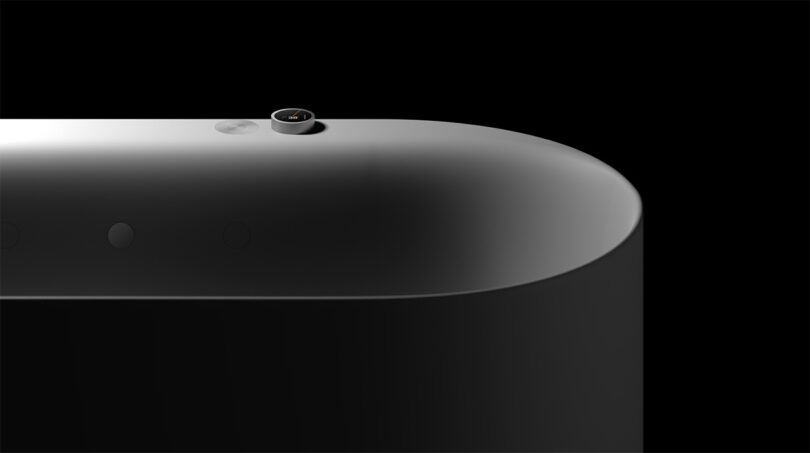 Side view of the gently sculpted perimeter of the AquaIntelli tub set against a black background.