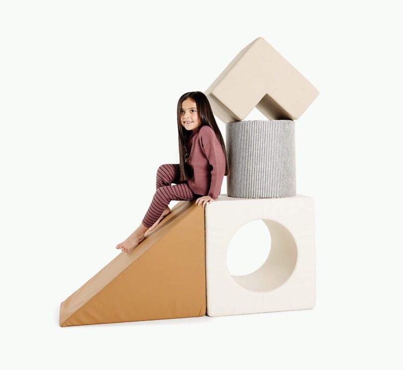 girl sitting on foam blocks