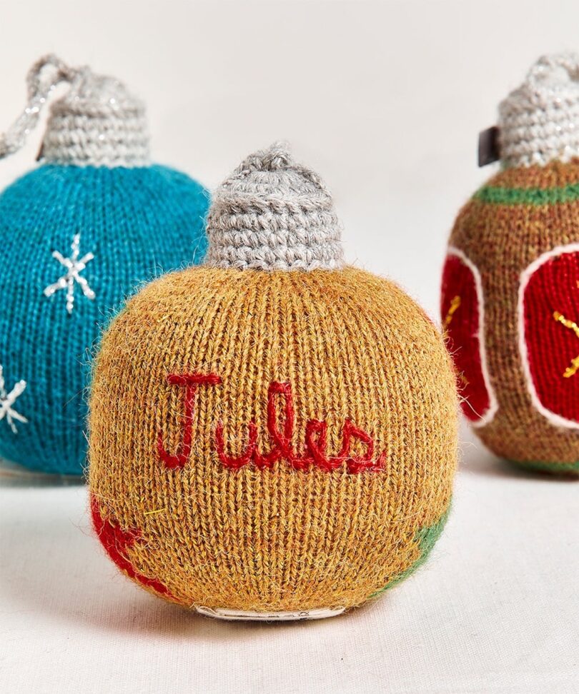 three personalized knitted ornaments