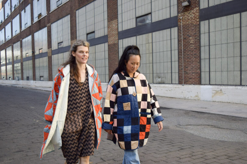 two women wearing quilted coats walking together