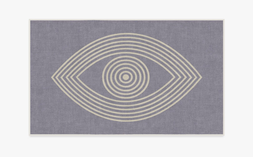 Large area rug from Ruggable x Johnathan Adler collection with Greek evil eye motif in center.