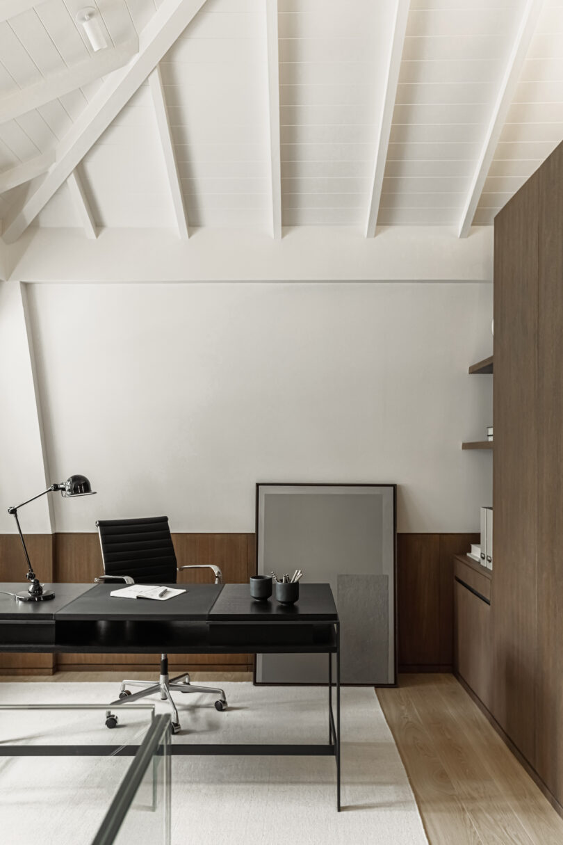 Open-plan study room with concealed storage and a minimalist desk setup