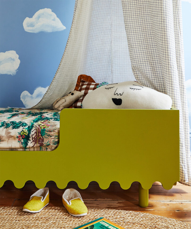 cloud pillow on wavy green toddler bed