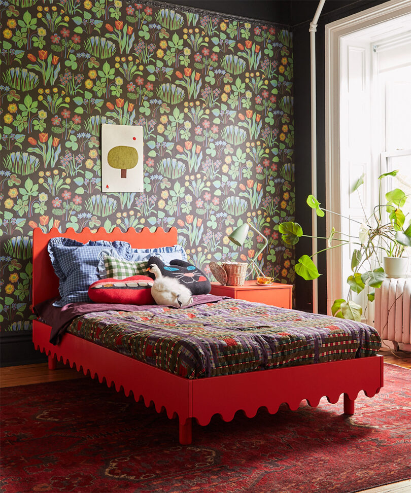 wavy red twin bed in wallpapered room
