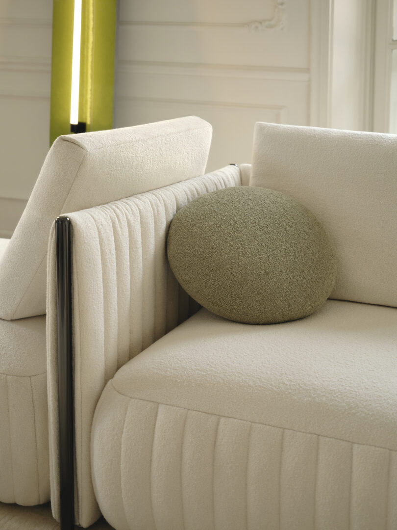 round grey cushion on white sofa 