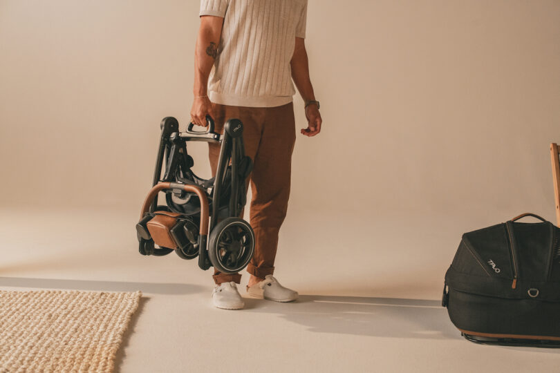 man carrying a pet stroller