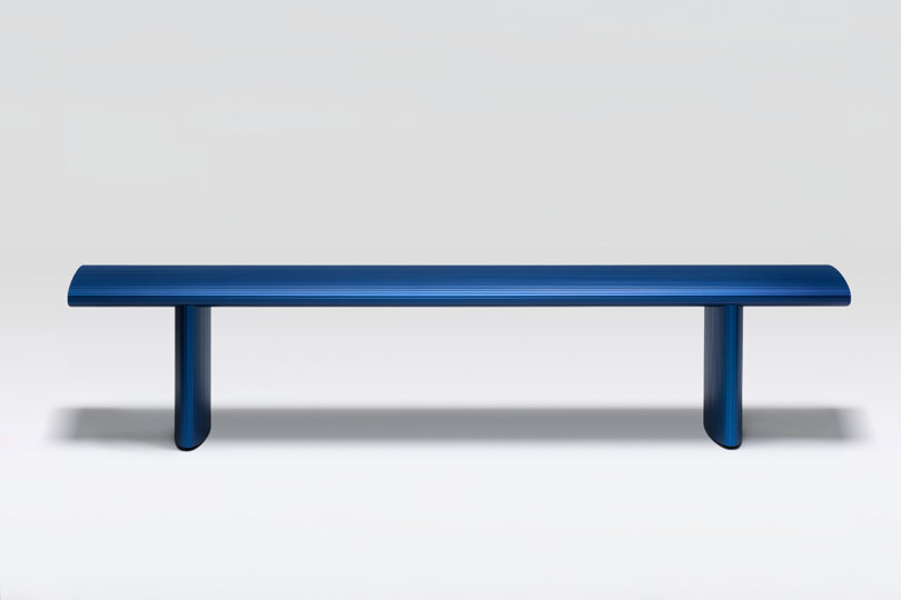 bright blue aluminum outdoor bench on white background