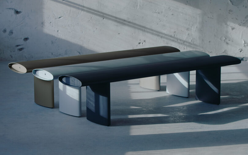 three modern aluminum benches lined up in a row