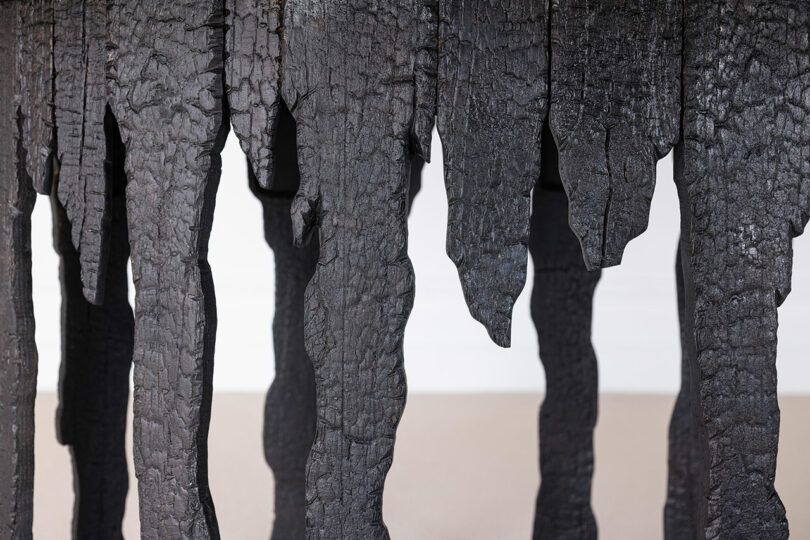 Detail of table legs that look like tree bark.
