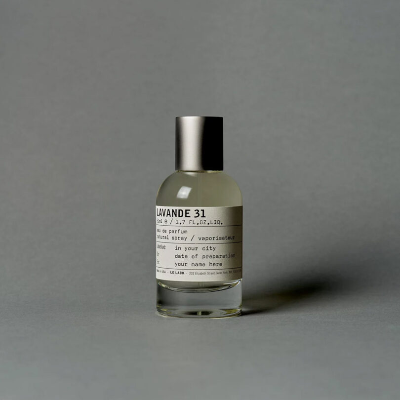 glass perfume bottle reading LAVANDE 31 on a grey background