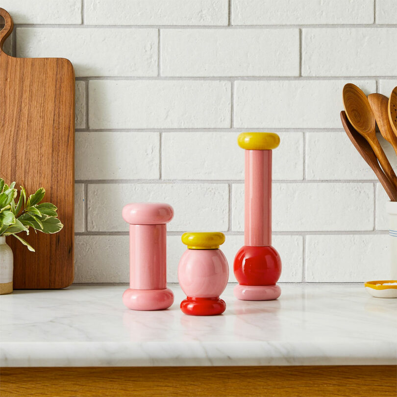 trio of pink and yellow shiny modern salt and pepper grinders