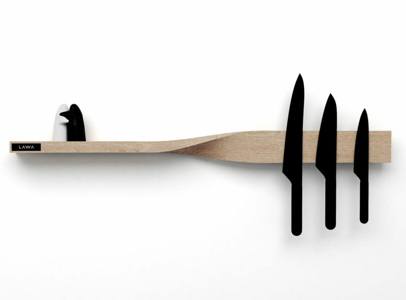 A wooden twisted wall shelf designed to hold knives magnetically