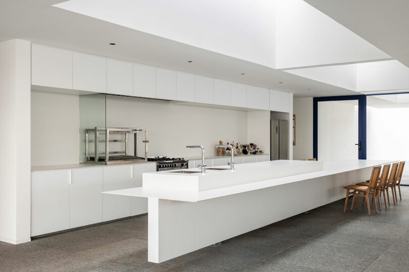 interior view of minimalist white kitchen with long island