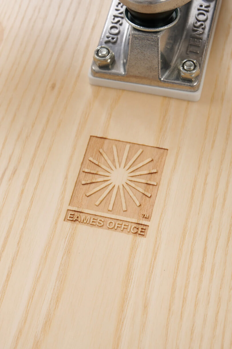 Close up of Eames Office engraved logo across the Eames Lounge cruiserboard in Ash and White