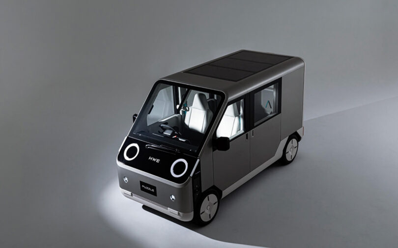 Overhead side exterior view of boxy Puzzle van concept in shadowed light