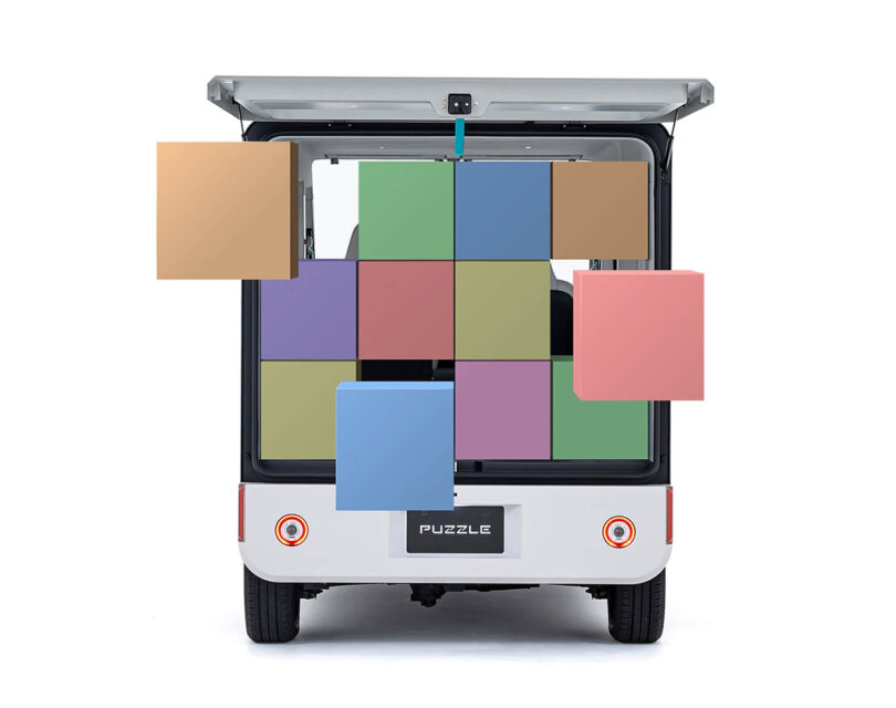 Colorful boxes situated inside the Puzzle concept van to illustrate its load capacity