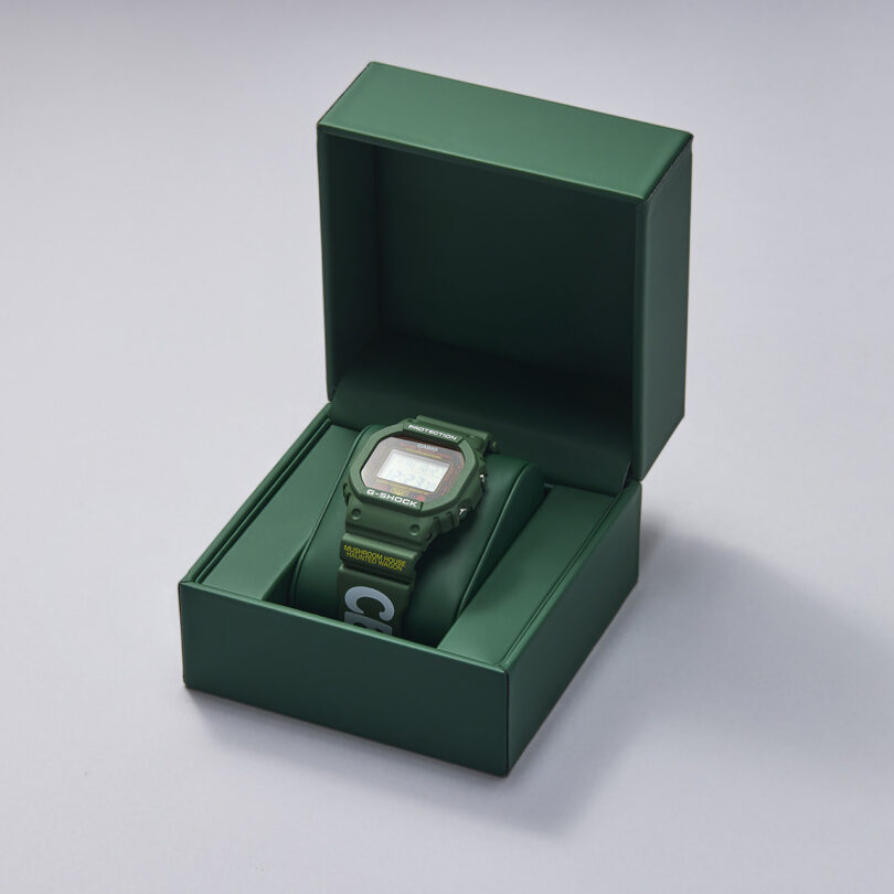 Online Ceramics x Hodinkee Casio G-SHOCK digital watch in its green padded case packaging with lid open on display