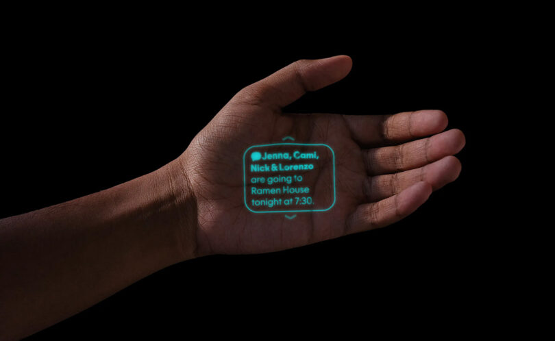 Open palm onto which is projected a green laser ink display with a text message about dinner plans.
