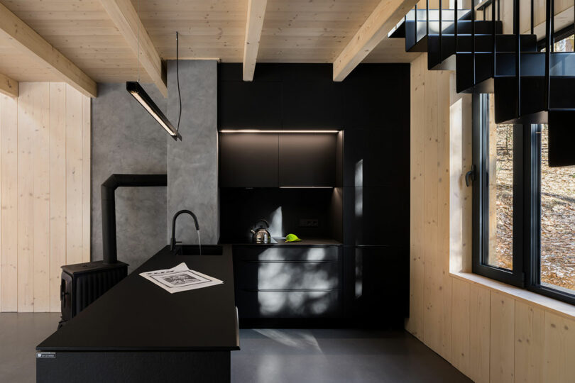 modern black kitchen with light wood details
