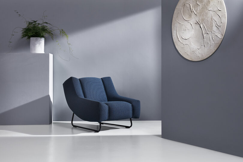 navy blue chair in styled interior space