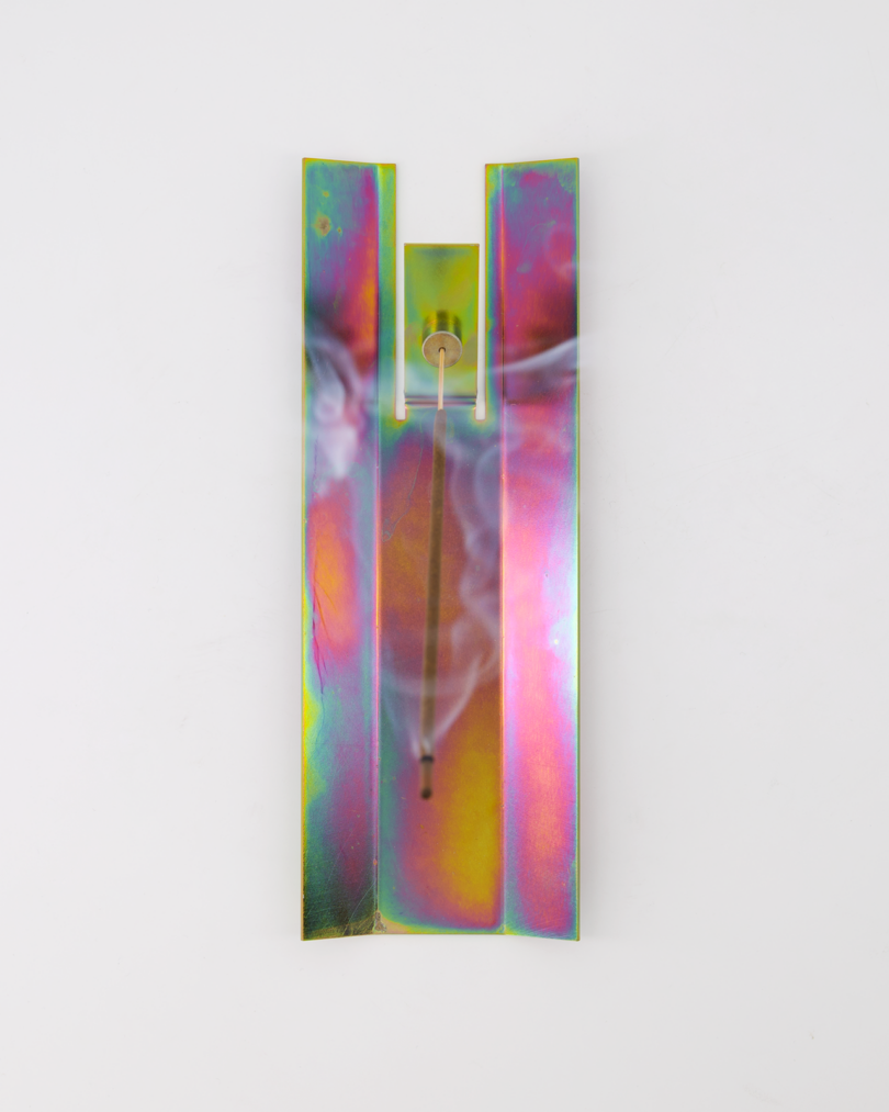 overhead image of a rainbow metallic incense holder