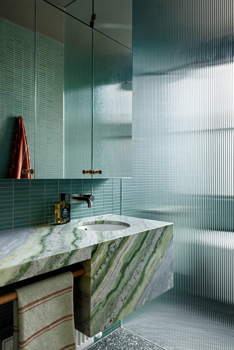 angled view of modern bathroom in green hues