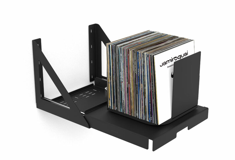 side angled view black wall-mounted pull out shelf that holds and rotates stored vinyl records