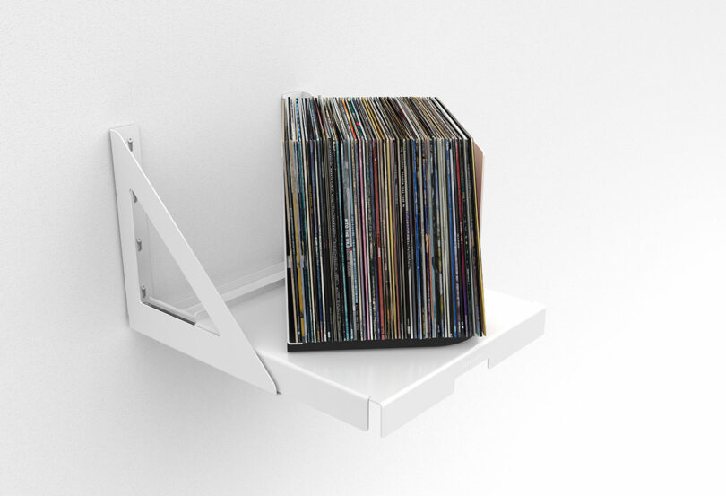 view white wall-mounted pull out shelf that holds and rotates stored vinyl records