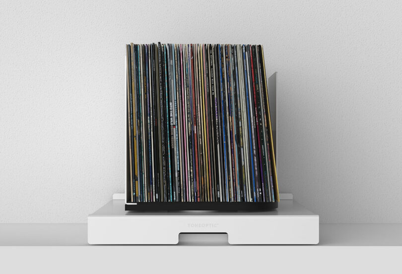 front view of white pull out shelf that holds and rotates stored vinyl records