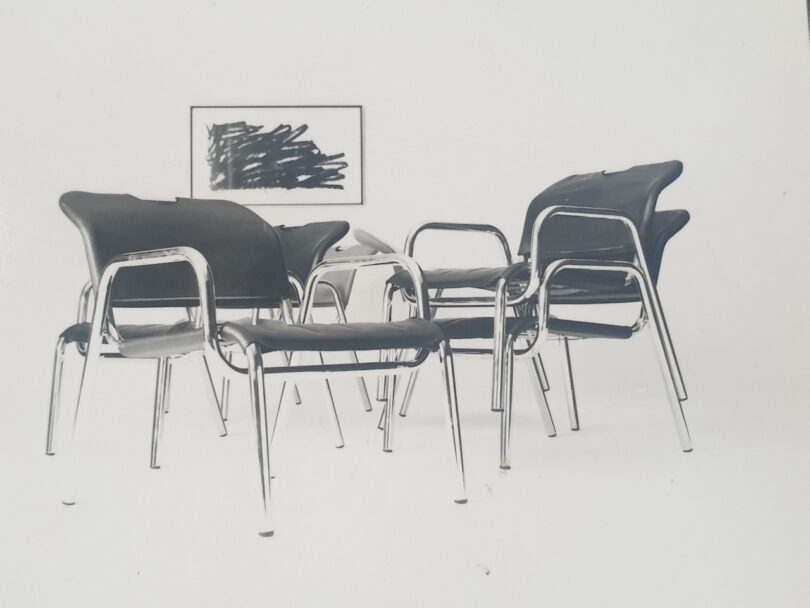 black and white photo of black lounge chairs