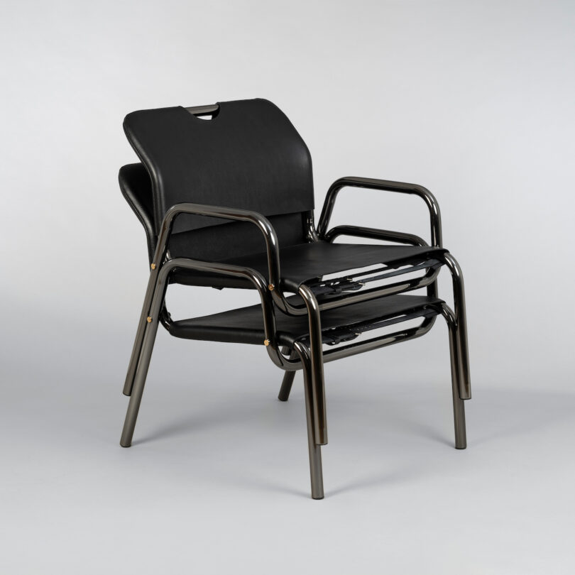 two black leather lounge chairs stacked on top of each other