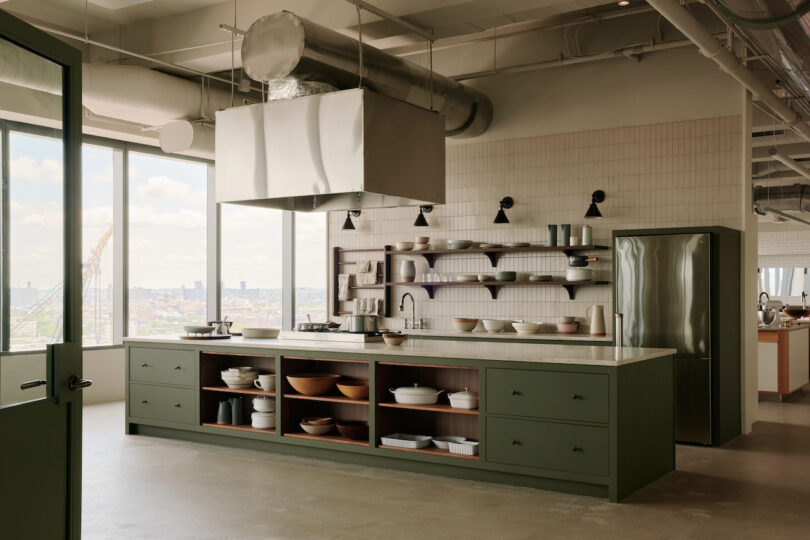 green kitchen island in high-rise office