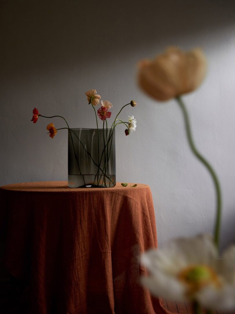flowers in a vase on a clothed table