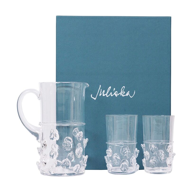 two water glasses and a pitcher next to a blue box