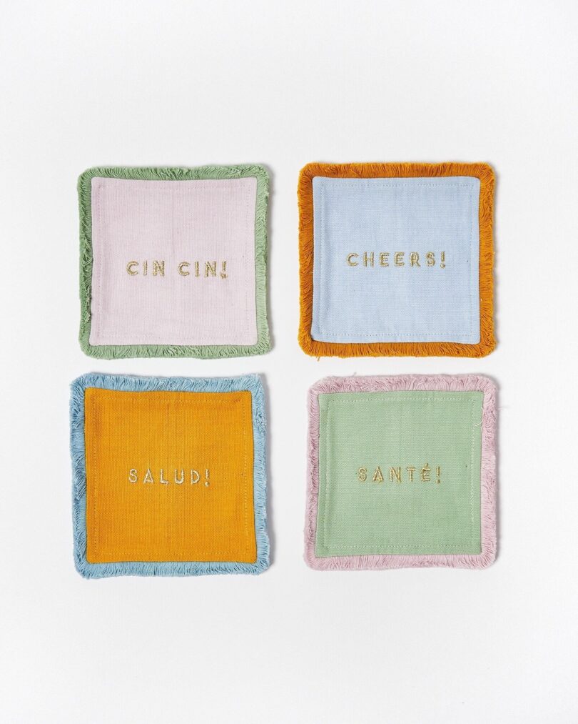 four pastel embroidered cocktail napkins