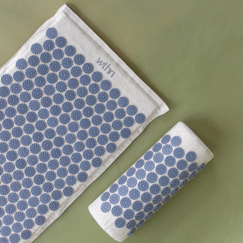 blue and white acupressure mat and pillow