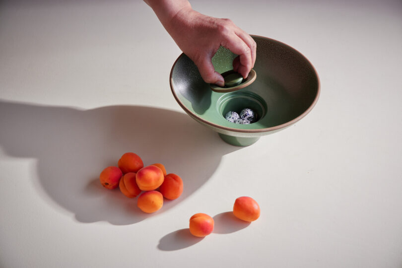 ceramic bowl holding orange fruit