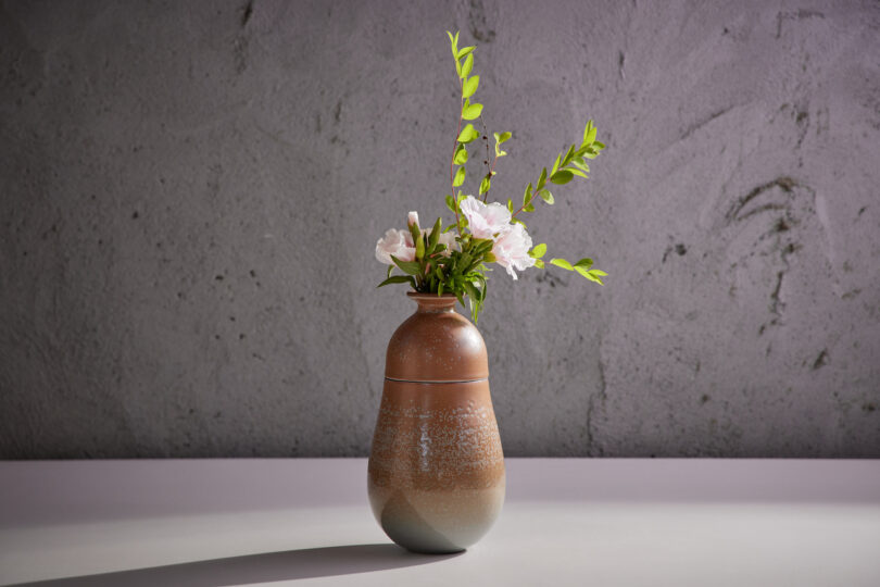 vase with white flowers and greenery